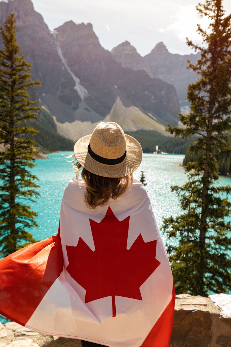 Explore the beauty of Moraine Lake in Alberta, Canada, with a stunning view and a Canadian flag.
